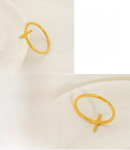 Detail of 18K gold-plated stainless steel cross ring with minimalist adjustable design