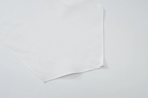 Close-up of precision stitching and premium white woven fabric texture on the dress