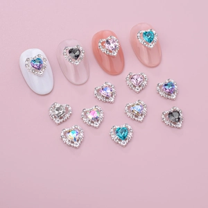 Macro detail of heart-shaped nail gems with alloy base and colorful rhinestones