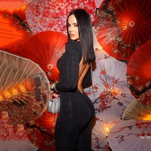 Detail showing the sexy open-back design of a black long sleeve glitter jumpsuit
