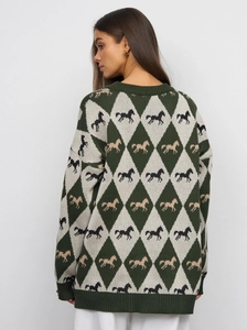 Detail of vintage diamond pattern knit sweater with horse jacquard and ribbed cuffs