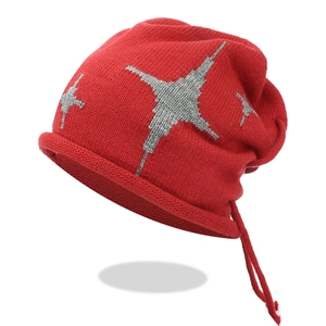 Red knit slouchy beanie with grey star patterns and adjustable drawstring closure