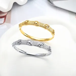Minimalist 18K gold and silver plated bangle set with embossed teardrop texture