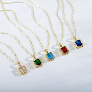 Detail view of five gold titanium necklaces with emerald-cut zirconia in multiple colors