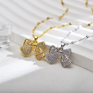 Elegant bow pendant necklace with zircon stones on a minimalist gold and silver chain