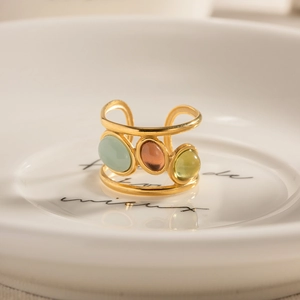 Vintage gold-plated stainless steel ring with three colorful natural stones in a ceramic tray
