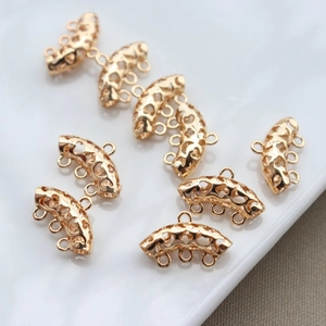 Detailed macro view of gold-plated hollow curved pipe spacers for handmade jewelry DIY