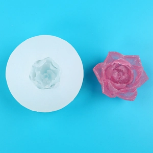 Macro view of a round silicone peony mold and a finished pink glittery resin flower