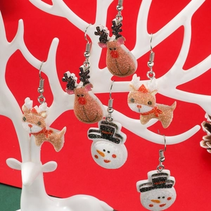 Cartoon Christmas acrylic earrings featuring Santa, reindeer and snowman on a display stand