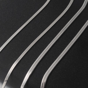 Macro shot of silver titanium steel flat snake chain necklace with high gloss finish