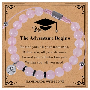 Detail of pink zebra stone bracelet with compass charm on graduation gift card
