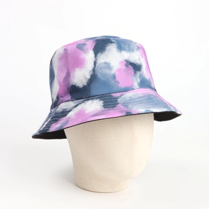 Detail of a tie-dye bucket hat showing stitching and black lining on a mannequin
