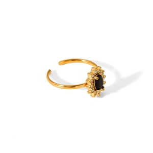 Detail of adjustable gold ring with black oval gemstone surrounded by white zircons