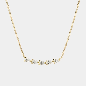 Detailed view of gold chain necklace featuring five prong-set pear cut zircon stones
