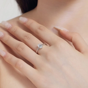 Close-up of S925 sterling silver ring with oval ice-cut zirconia on a model hand