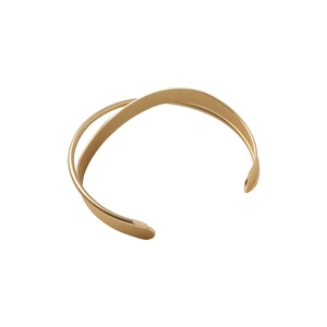 Minimalist gold geometric crossover bangle with polished metallic finish and open design