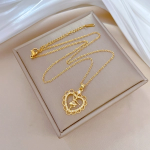 Gold titanium steel necklace with crystal heart and ballet dancer pendant on silk