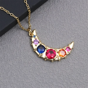 Detailed close-up of a gold moon pendant necklace with colorful micro-inlaid zircon stones