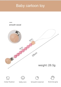 Detailed view of pink silicone and beech wood baby pacifier clip with dimensions and specs