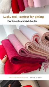 Detailed view of thick wool scarves with tassels in red and pink for winter warmth