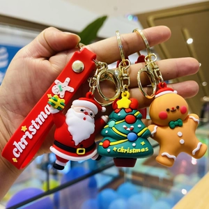 Cute Christmas cartoon keychains featuring Santa, tree, and gingerbread man with red strap