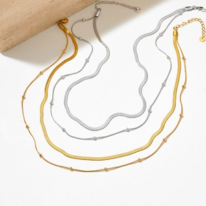 Double-layered stainless steel necklace featuring gold and silver snake and bead chains