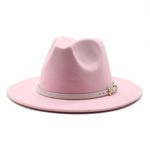 Detail view of pink wool felt fedora featuring a beige leather band with gold buckle