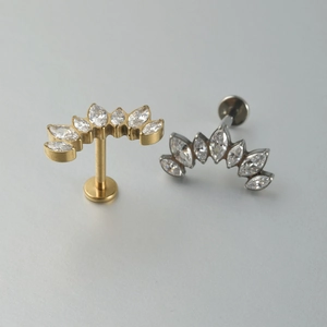 Macro detail of G23 titanium labret studs with marquise zirconia and lab opal inlays