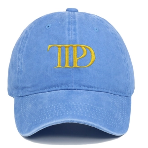Close-up of yellow TPD 3D embroidery on sky blue cotton twill baseball cap