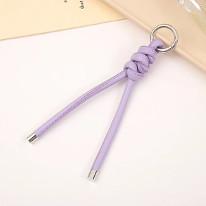 Purple PU leather braided keychain pendant with silver metal ring on a white tray