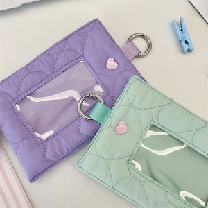 Detailed view of quilted heart card holders in purple and mint green with clear ID windows