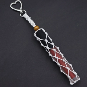 Detail of handmade woven cotton lipstick holder with silver heart carabiner and wood bead