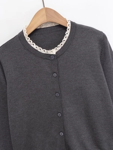Vue détaillée du cardigan en maille gris foncé avec bordure en dentelle blanche au col