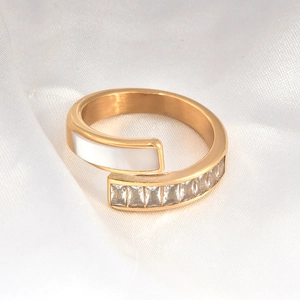 Close-up of golden 18k titanium steel ring with white shell inlay and rectangular zircons