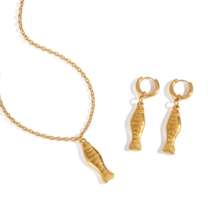 Elegant gold fish pendant necklace and earring jewelry set on a clean white background