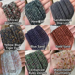 Assorted natural gemstone beads collection featuring Jasper, Tiger Eye and Opalite spheres