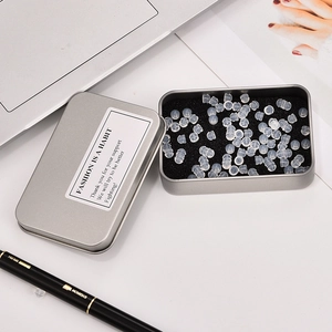 Transparent bullet silicone earring backs set in a silver tin box with sponge insert