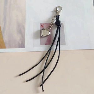 Minimalist heart pendant keychain with long black wax cord tassels and silver metal clasp