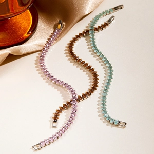 Close-up of sparkling marquise-cut crystal bracelets in pink, blue and amber tones