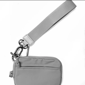 Close-up of grey nylon mini coin pouch with wide webbing strap and metal spring hook