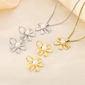Elegant gold and silver bow pearl jewelry set with necklace and matching earrings