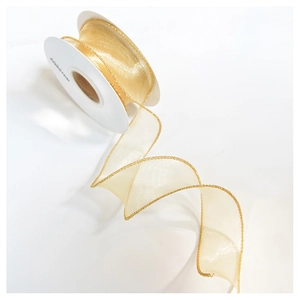 Close-up of golden translucent organza ribbon with metallic edges on a white spool