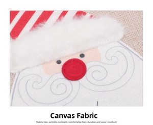 Detailed macro view of linen Santa Claus placemat with festive embroidery and textures