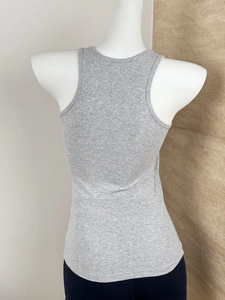 Close-up of gray racerback sports top showing knitted texture and slim fit on mannequin