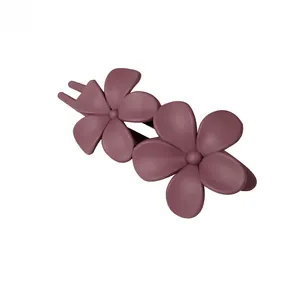 Detailed view of matte dark rose purple double flower resin hair clip with duckbill clip