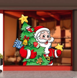 Detailed view of Santa Claus and Christmas tree window stickers on a warm glass pane
