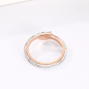 Macro view of rose gold snake ring with micro-paved crystals and colorful gemstones