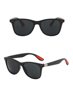 Detail view of classic sunglasses with black frame and red accents on inner temples