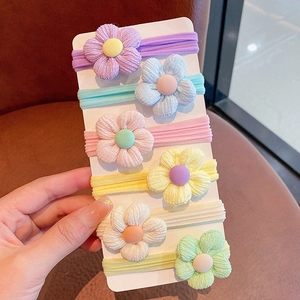 Close-up of 6 colorful floral elastic hair ties on display card with corduroy texture