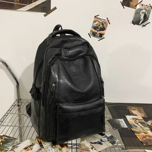 Minimalist black PU leather laptop backpack with multiple pockets and silver metal rack